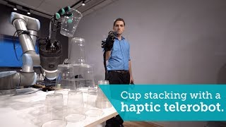 Cup stacking with a haptic telerobot