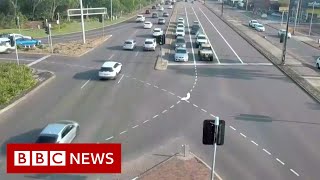 Footage captures car careering across eight lanes in Australia - BBC News