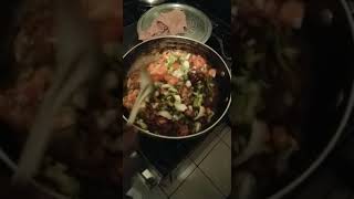 cooking toncornmeal with mixed vegetables and stew chicken