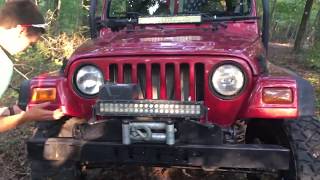 Jeep on 33 inch MTZ and 35 inch Toyo tires go down tight trail.