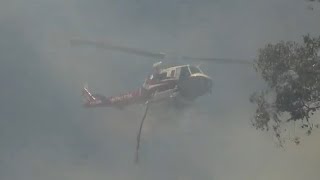 Firefighting Helicopter makes Water-Drop on Freeway Grass Fire in Sacramento CA