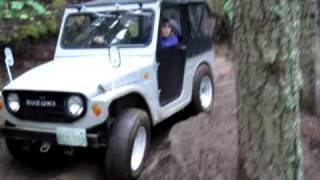 Suzuki LJ10 basically stock at Evan's Creek getting over some ruts