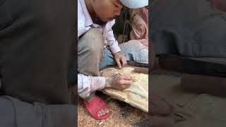 Wood carver creates fish scales