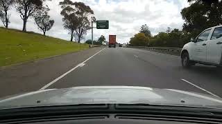 2015 White mirait.com.au Izuzu ute. Form 1 lane, squeezes between 2 trucks. Hume motorway, Woodbine