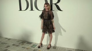 Cara Delevingne pose for the photographers at the Dior Fashion show in Paris