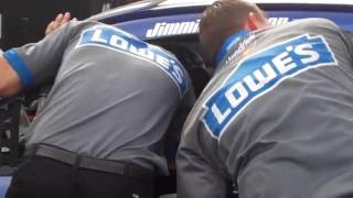 Crew members work on 48 car of NASCAR points leader Jimmie Johnson at Michigan International Speedwa