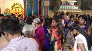 Sri Kamadchi Ampal Temple: A Hindu priest passes around a ceremonial candle tray for blessings