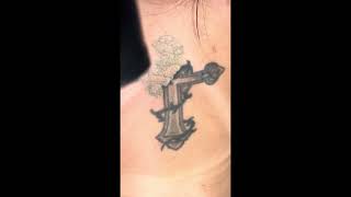 Cross tattoo on back of a female