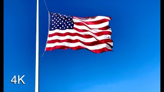 Large American Flag Waving in the Wind Sound Effect and Stock Video | Solid Blue Sky Background | 4K