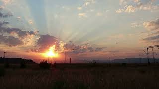 Romantic Sunrise Over Tranquil Landscape with Passing Train