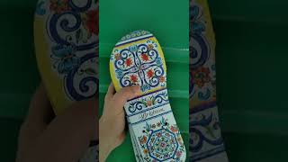 Digital printer printing on shoe insoles.