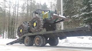 Loading the Tree Farmer C5D skidder onto the M322 trailer