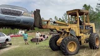 Old forklift loading old cars