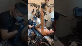 Young fit Asian man screaming during tattoo session on his bottom 3