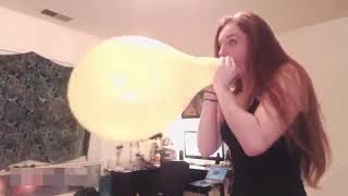 Balloon Girl Blows The Yellow Balloon to its Maximum Capacity