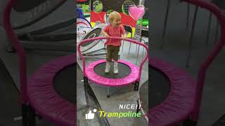 Kids Bouncing on Pink Trampoline with Safety Handle, Having a Blast at the Exhibition!