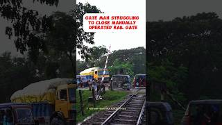 Gate man struggling to close a manually operated Railgate