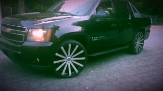 2010 Chevy Avalanche sitting on 26" Velocity VW 12 wheels leaving RimTyme Stone Mountain