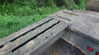 Volvo 220 excavator loaded on the M870a1 using ramps.