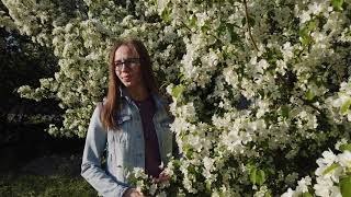 Beauty woman enjoying nature in spring apple orchard