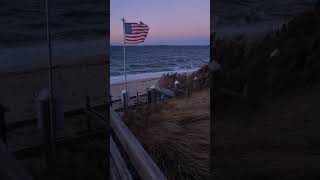 American flag at the end of summer season after enduring rain & strong wind gusts • Southampton, NY