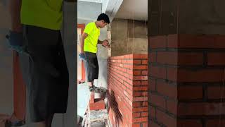 Bricklayer demonstrates his wall building skills