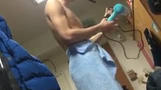 Fit young Asian man topless after shower with his roommates