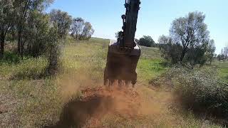 362-Volvo excavator clearing trees to work field