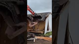 mini excavator demolitining the building