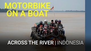 Motorbikes on a fishing boat crossing the river | Indonesia