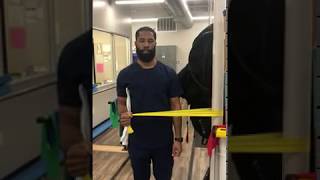 Standing shoulder external rotation with theraband