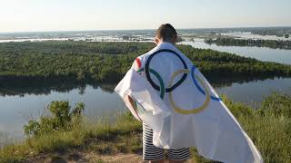 Boy waving flag the Olympic Games outdoors