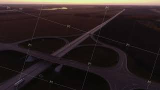 Aerial view. Road junction at sunset. Trucks are driving on the highway. Cars drive on a country