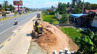 Clearing weed and burying drainage system in front of the house next to the motorway.