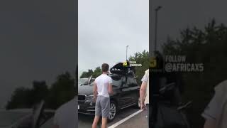 2 African guy sneak in family moving storage on top of car