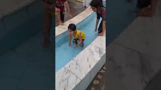 Funny baby in swiming pool