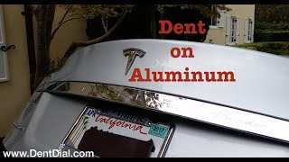 Tesla Model S dent on the trunk lid repair without repainting.  Paintless dent repair by DentExpert