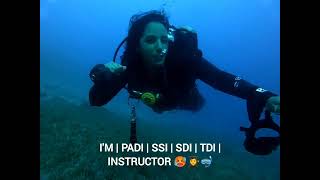 female scuba diver taking regulator out of her mouth