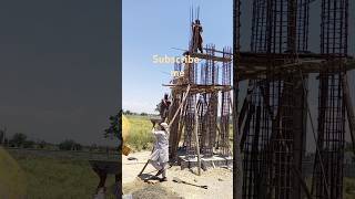 Laborers are working on the concrete in the scorching heat while the steel pickers are working