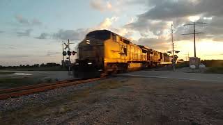 CSX 7764(Dash 8-40CW YN2) and 126(AC440CW YN2) Lead M338 in the Beautiful Sunset