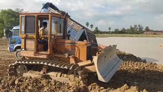 Powerful Extreme bulldozer use power push stone into the water with dump truck 5T unloading.