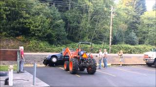 Kubota MX5100 rolls car over