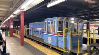 Work train passing 42nd St-Bryant Park