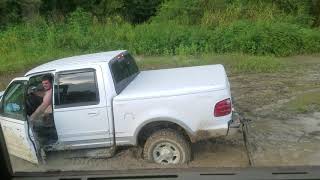 M1078 LMTV recovering F150 from a mud hole