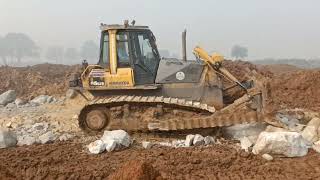 Caterpillar D85ESS Bulldozer Ripping Hard Rock AND white material for road construction