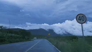 Going down a curved highway through a mountain range| True Nature |