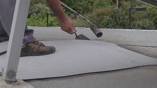 Rooftop Waterproofing Resurfacing With Blowtorch Fire Heat Adhesives Demonstration