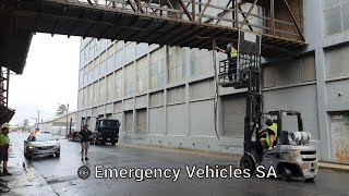 Nissan forklift helping police to clear debris from building impact