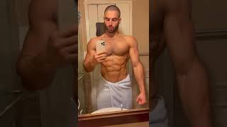 Muscle stud Kamal Zatar showing off in the bathroom mirror