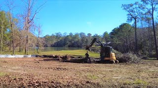 Taking down trees with John Deere Excavator